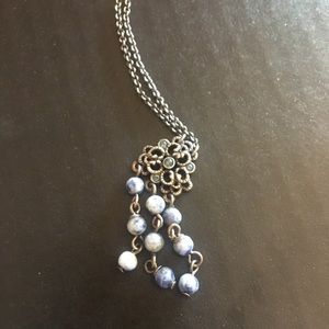 Silver flower necklace with dangling blue stones
